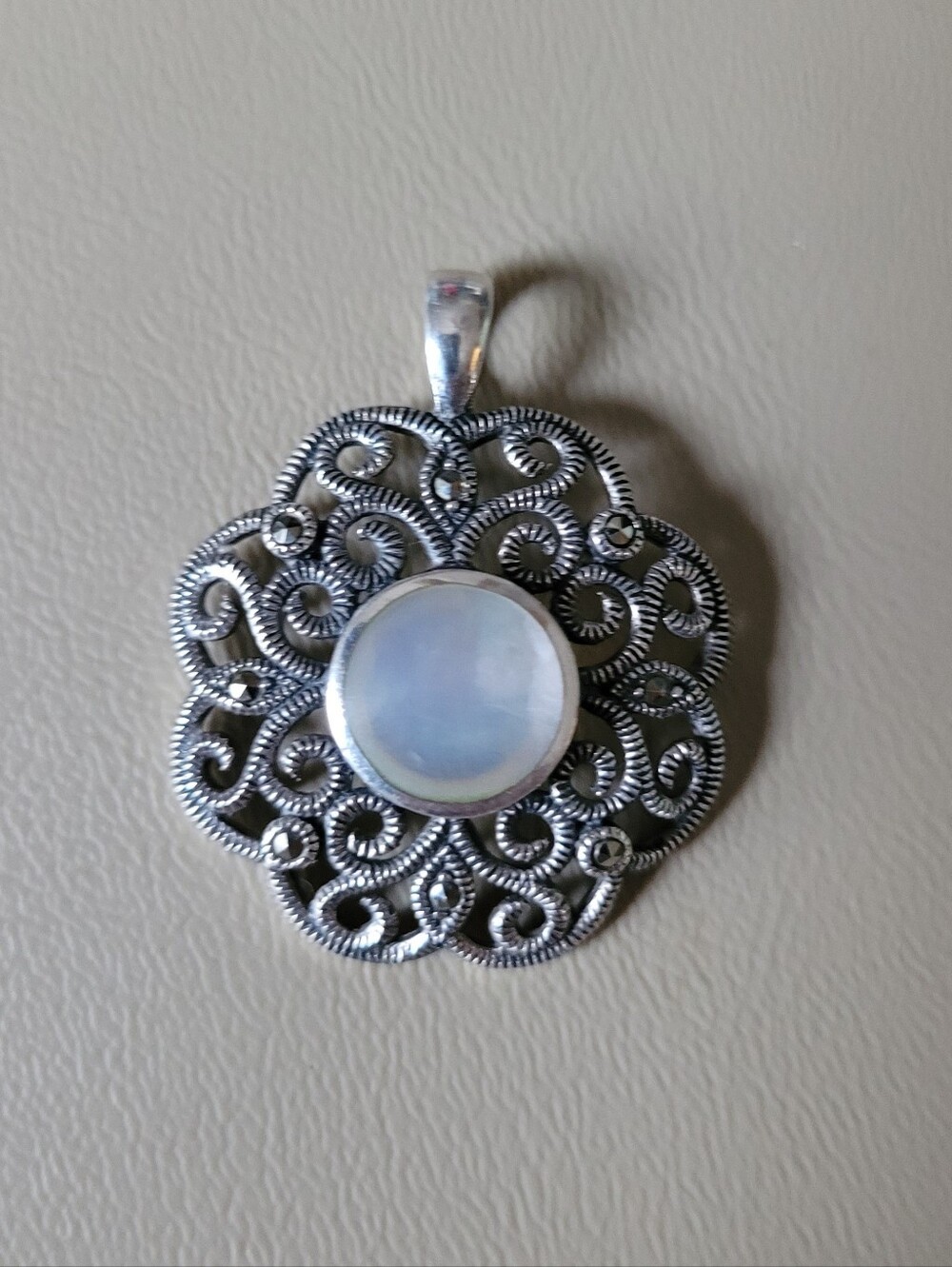 Vintage 925 sterling silver marcasite and mother-of-pearl filigree pendant.